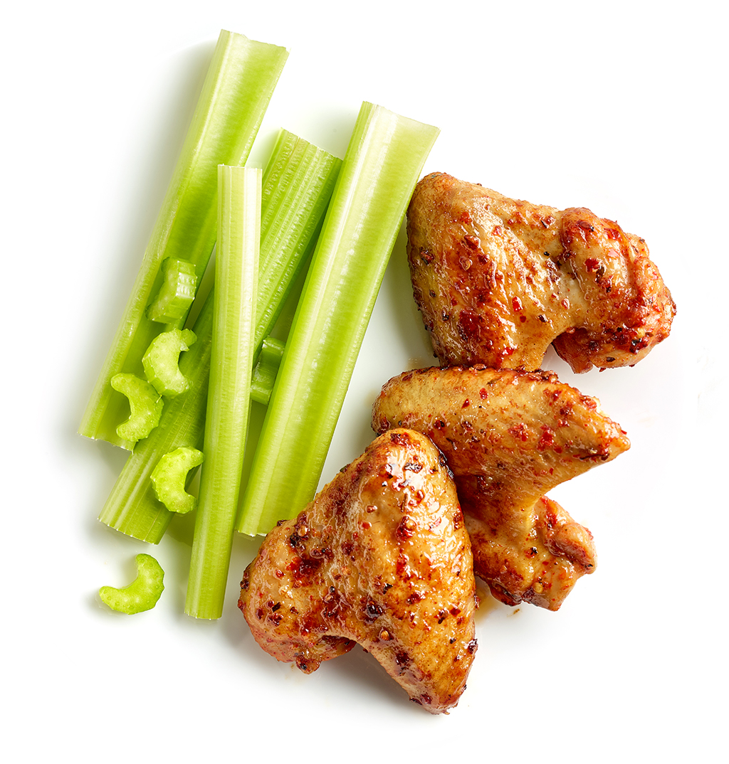 Chicken wings and fresh celery in pieces